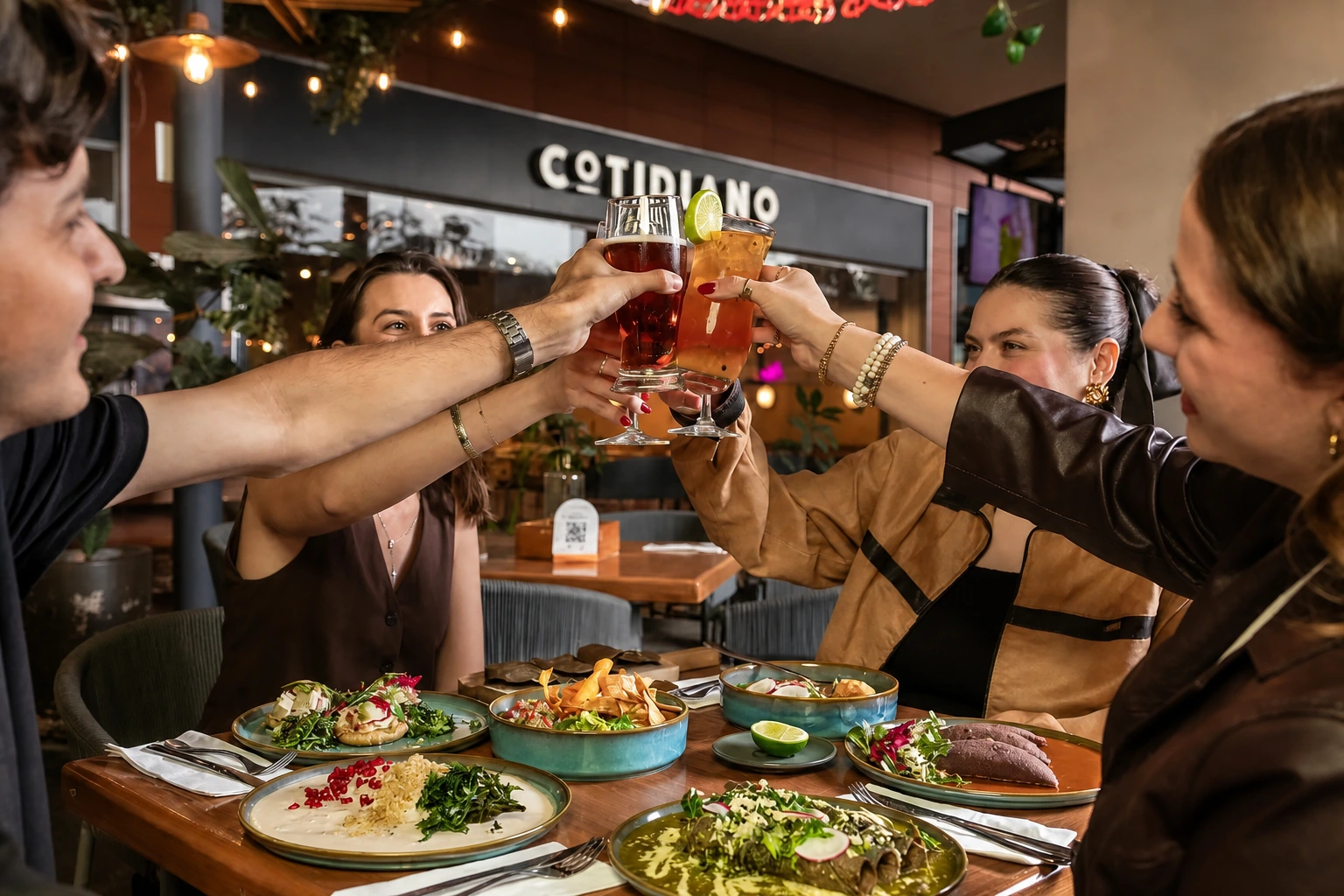 Friends sharing a toast over food and cocktails at Cotidiano Wynwood